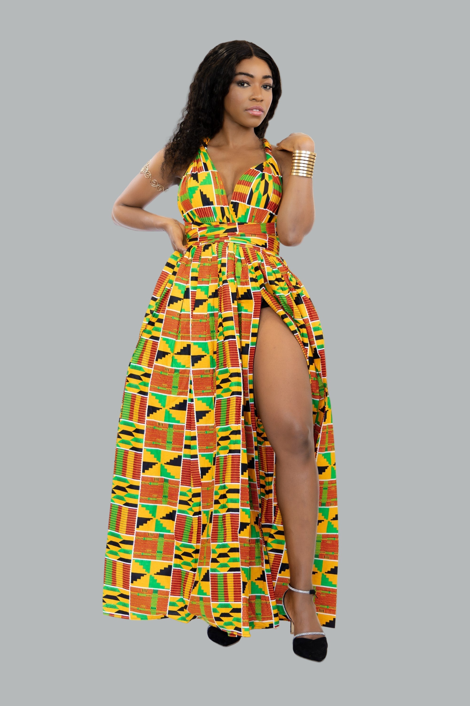 Woman wearing a colorful patterned dress on a grey background